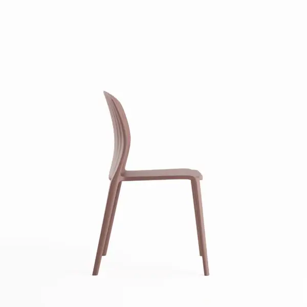 Side view of a blush pink plastic dining chair