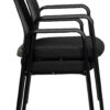 Stacked black upholstered office chairs with armrests